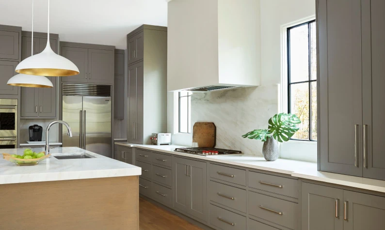 Kitchen renovation with waterfall stone island bench, completed by Renovaco Group Melbourne